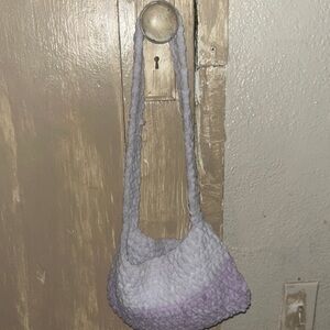 Purple crocheted handbag